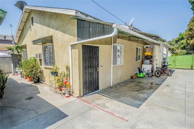 view of side of home featuring a patio area