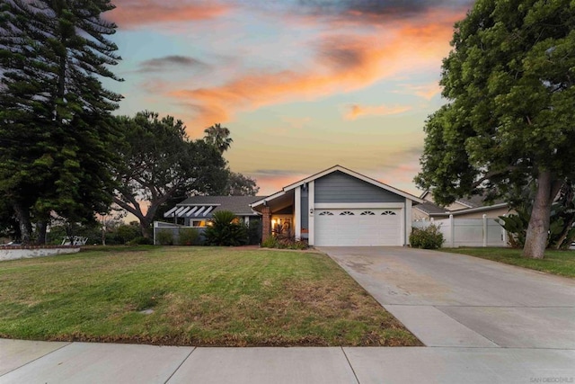 view of front of house with a yard and a garage