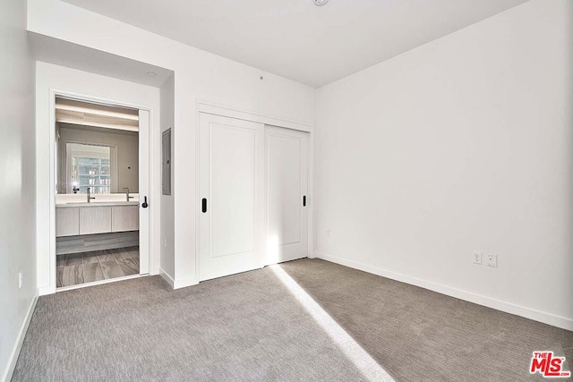 unfurnished bedroom with a closet and carpet floors