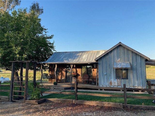 view of front of house with board and batten siding and metal roof