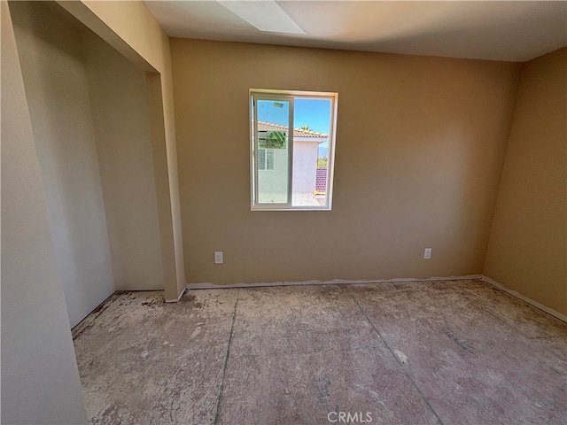 unfurnished room featuring a skylight