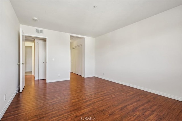 empty room with dark wood-type flooring