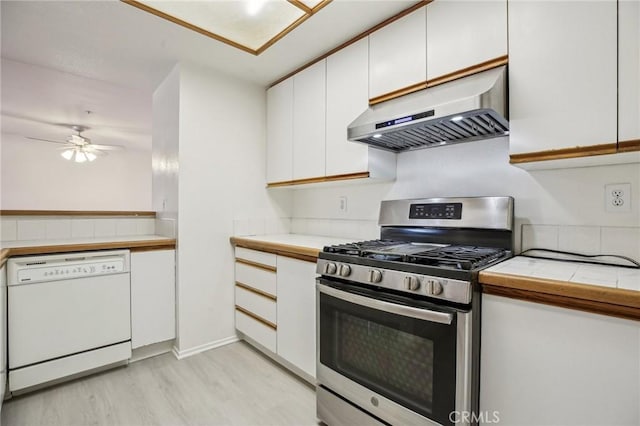 kitchen with stainless steel gas range, white cabinetry, light hardwood / wood-style flooring, dishwasher, and range hood