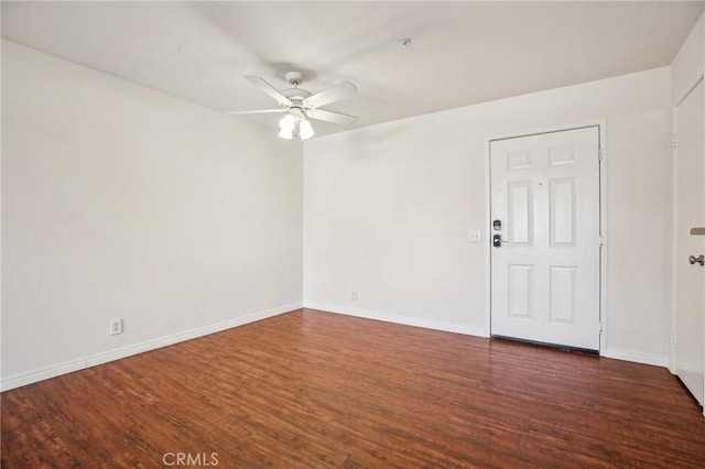 unfurnished room with ceiling fan and dark hardwood / wood-style floors