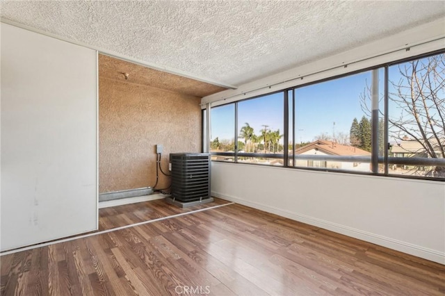 interior space with hardwood / wood-style floors and a textured ceiling