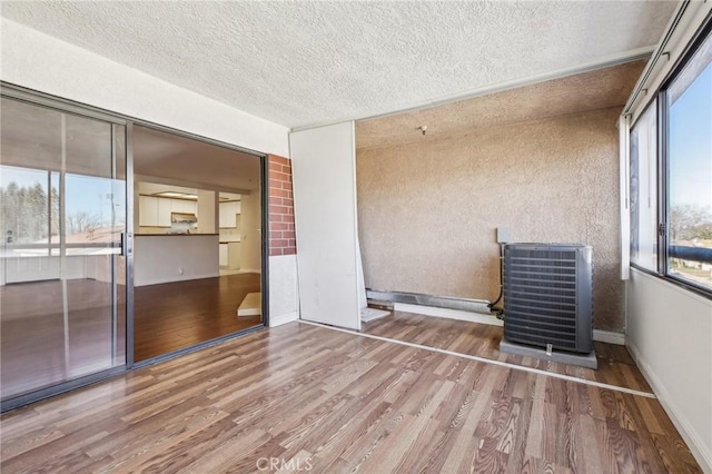 empty room featuring hardwood / wood-style floors and a textured ceiling