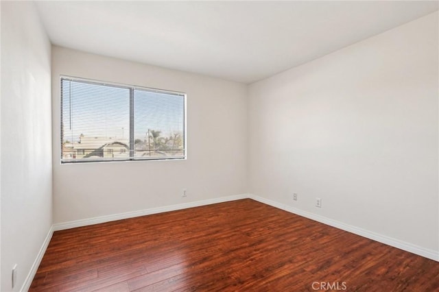 spare room featuring dark wood-type flooring