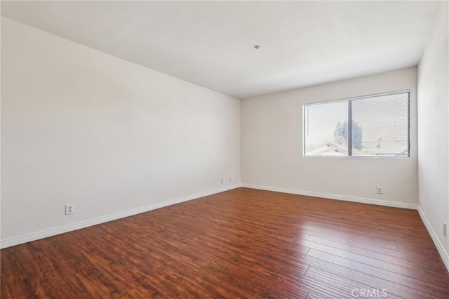 spare room with hardwood / wood-style floors