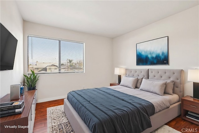 bedroom with dark hardwood / wood-style floors