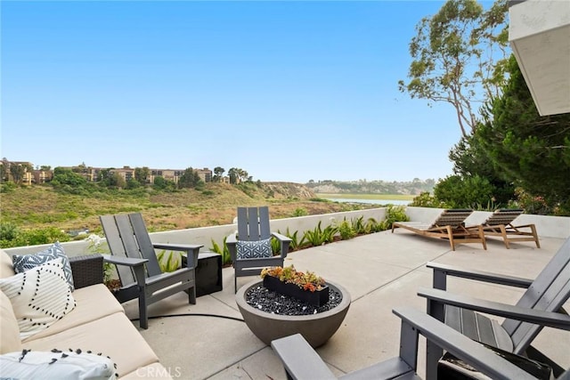 view of patio featuring an outdoor living space with a fire pit