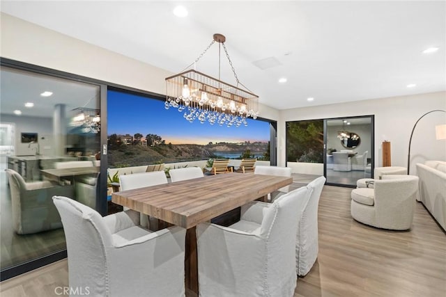 dining room with an inviting chandelier and light wood-type flooring