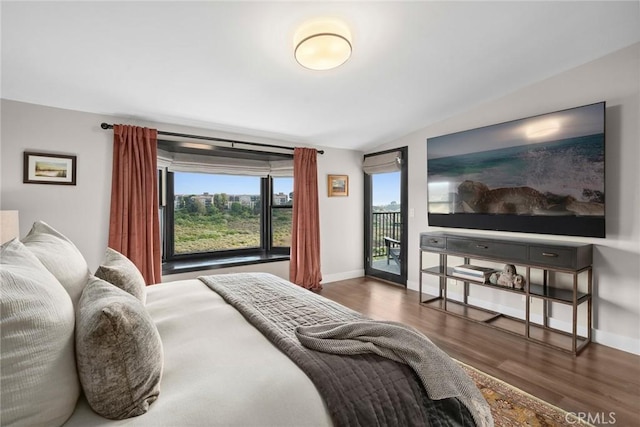 bedroom with access to outside, dark wood-type flooring, and vaulted ceiling