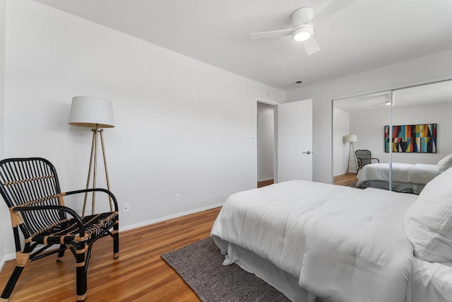 bedroom with wood-type flooring, a closet, and ceiling fan