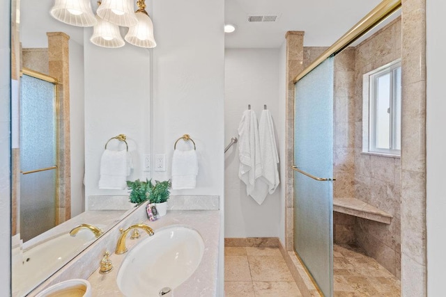 bathroom featuring vanity and a shower with shower door