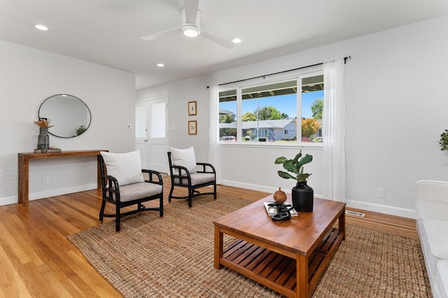 sitting room featuring light hardwood / wood-style floors and ceiling fan