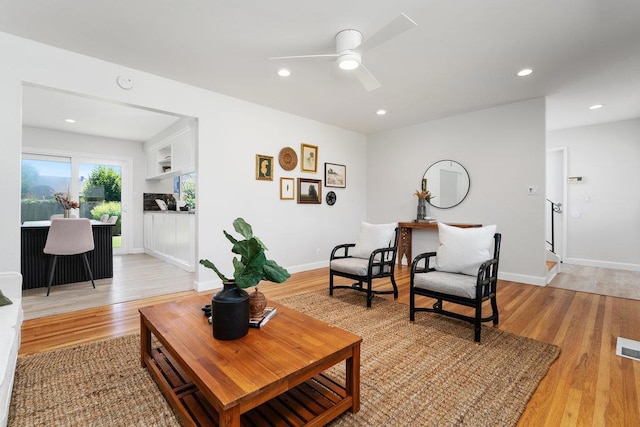 living room featuring ceiling fan and light wood-type flooring