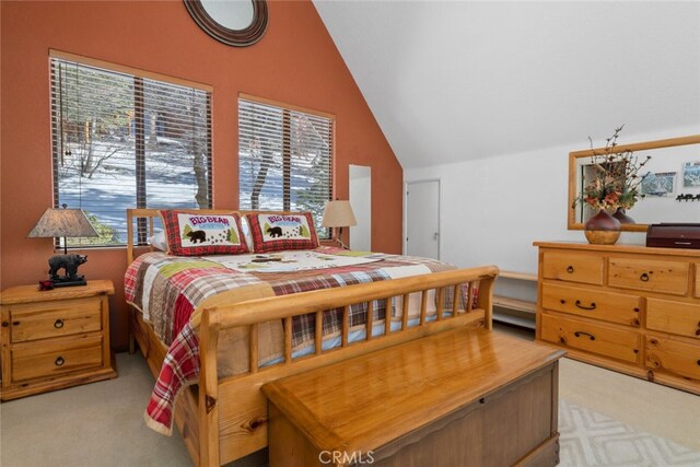 bedroom with light carpet and lofted ceiling