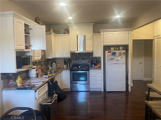 kitchen with dark hardwood / wood-style floors, tasteful backsplash, range hood, white cabinets, and stainless steel appliances