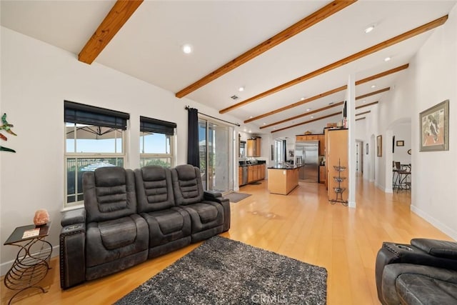 living room with arched walkways, baseboards, lofted ceiling with beams, light wood-type flooring, and recessed lighting