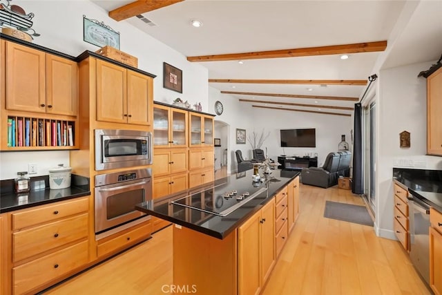 kitchen with visible vents, dark countertops, beamed ceiling, a center island, and stainless steel appliances