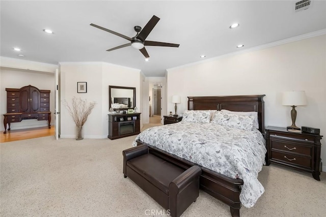 bedroom with baseboards, visible vents, crown molding, and recessed lighting