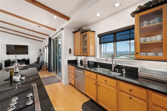 kitchen featuring open floor plan, vaulted ceiling with beams, light wood-type flooring, stainless steel dishwasher, and a sink