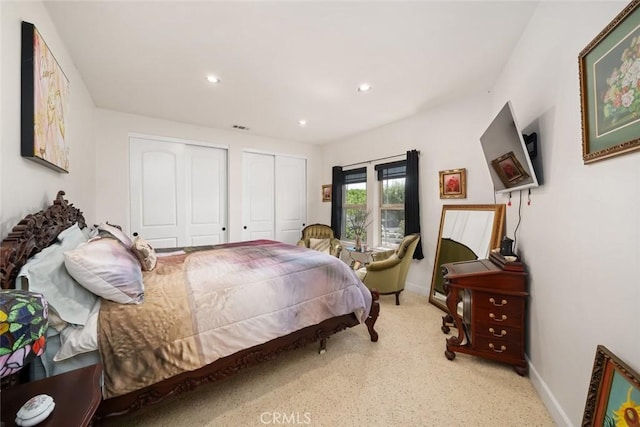 bedroom featuring visible vents, baseboards, multiple closets, and recessed lighting