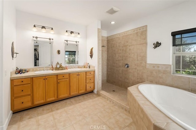 full bath with a bath, double vanity, a sink, and tiled shower