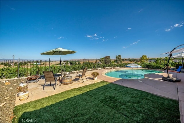 view of swimming pool featuring a fenced in pool, a lawn, an outdoor fire pit, a patio area, and fence