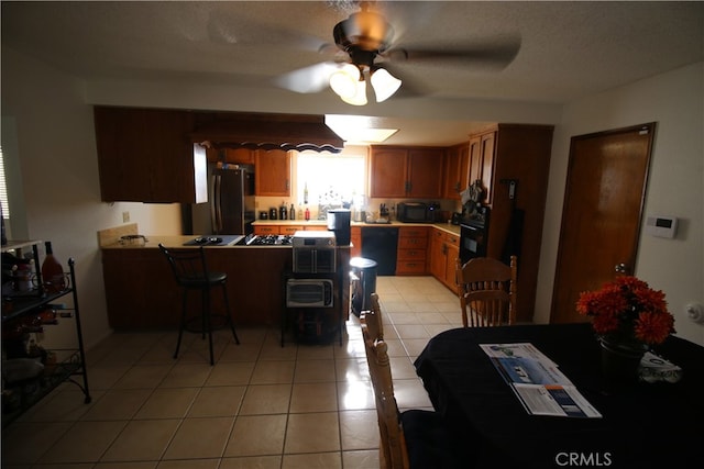 dining space with light tile patterned floors and ceiling fan