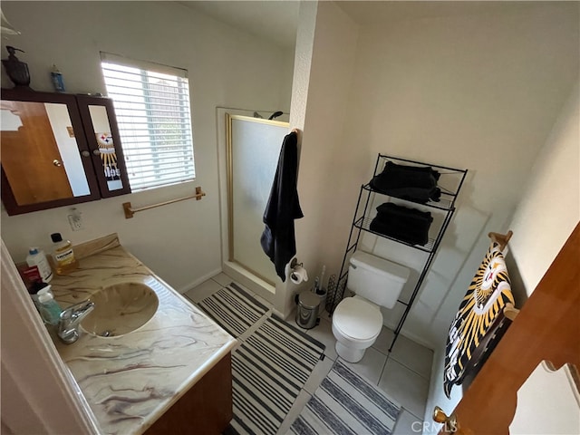 bathroom with tile patterned flooring, vanity, and toilet