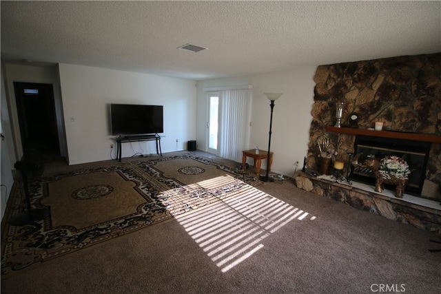 unfurnished living room with carpet, a textured ceiling, and a fireplace