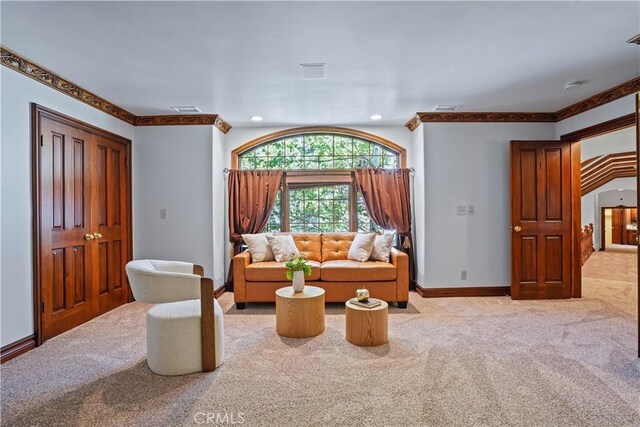 sitting room with light colored carpet and crown molding