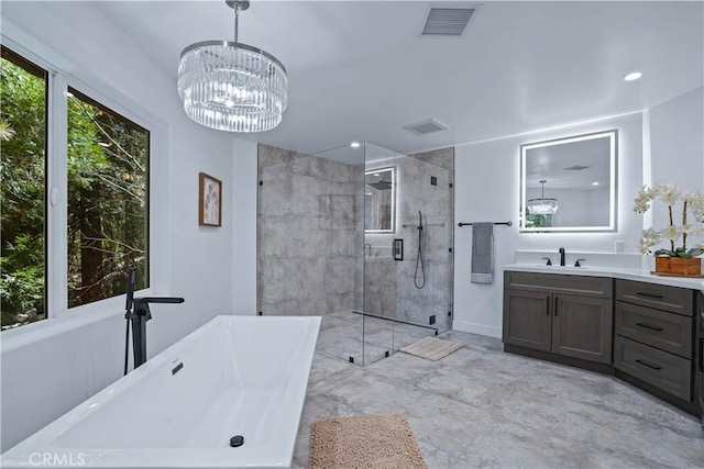 bathroom featuring vanity, plus walk in shower, and a chandelier