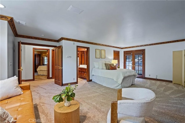 bedroom with ornamental molding, french doors, light carpet, and ensuite bath