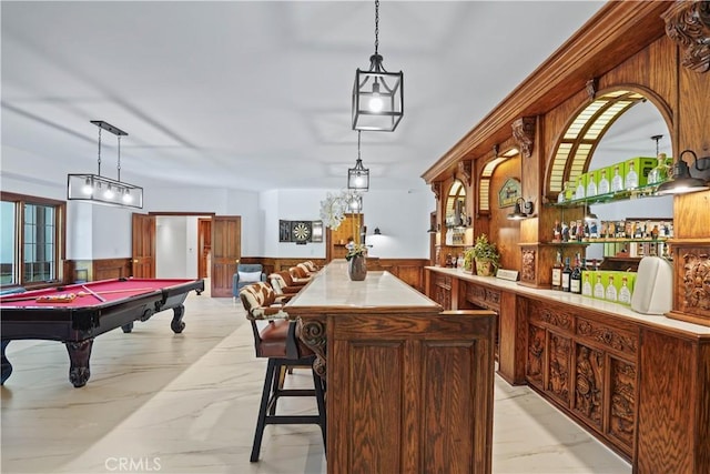 bar with wooden walls, decorative light fixtures, and billiards