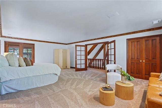 bedroom featuring carpet flooring, french doors, and ornamental molding