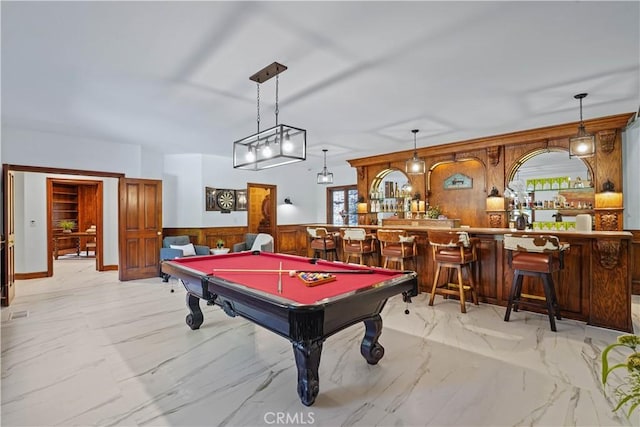 playroom featuring wooden walls, a wealth of natural light, billiards, and indoor bar