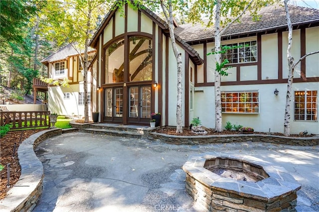 exterior space with french doors, a patio, and a fire pit