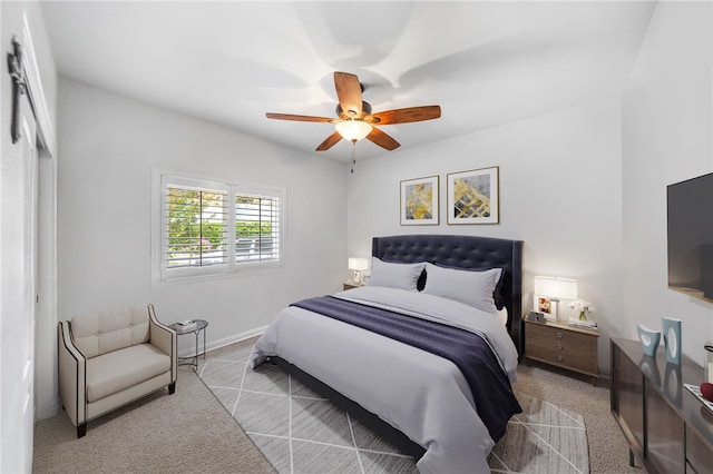 bedroom featuring ceiling fan and light colored carpet