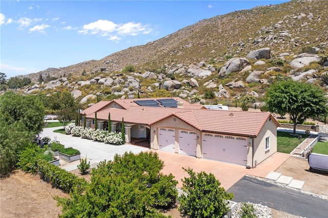 birds eye view of property featuring a mountain view