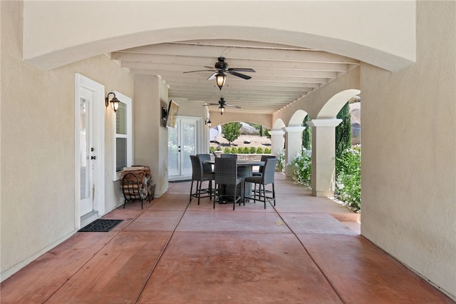 view of patio with a bar, ceiling fan, and french doors