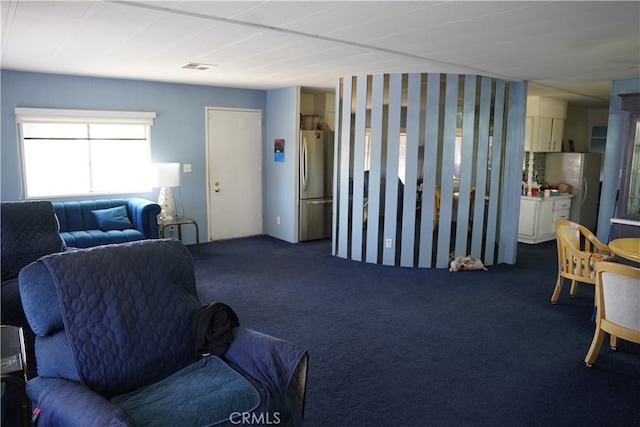 living room featuring dark colored carpet