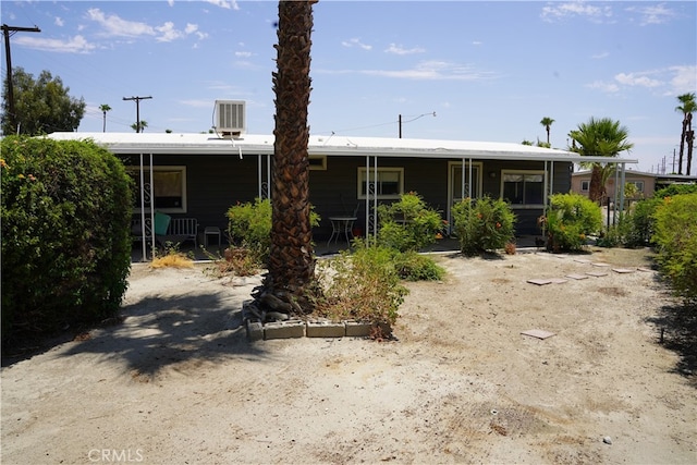 view of front of house with covered porch and central AC unit