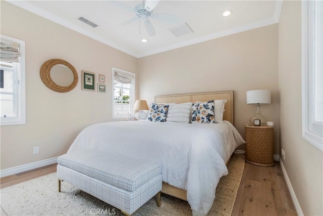 bedroom with ceiling fan, wood-type flooring, and ornamental molding