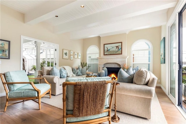 living room featuring beam ceiling and light hardwood / wood-style flooring