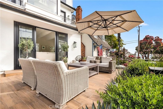 wooden terrace with outdoor lounge area