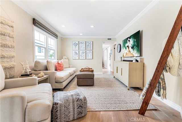 living room with hardwood / wood-style flooring and crown molding