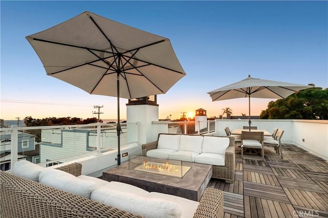 deck at dusk with an outdoor fire pit