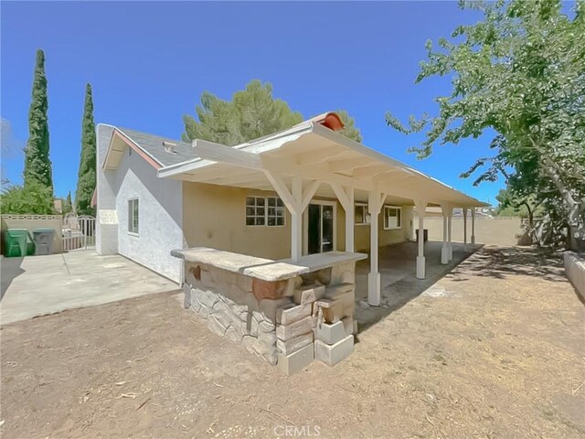 rear view of property featuring a patio